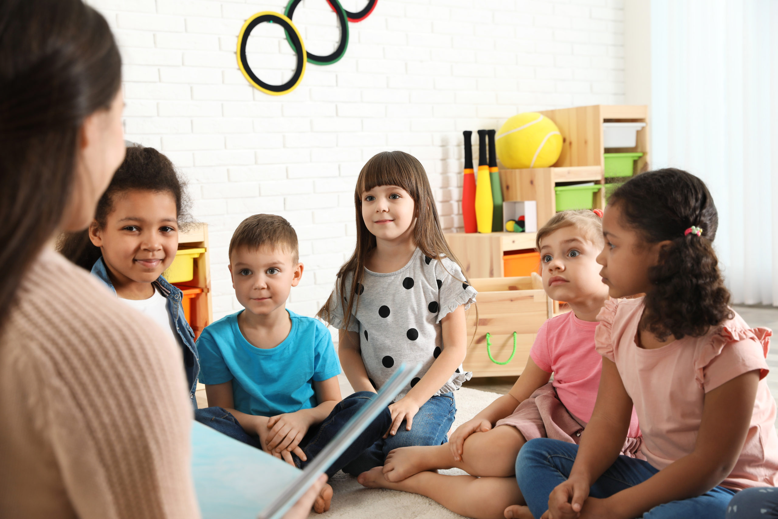 Children in a classroom attentively listening to a story